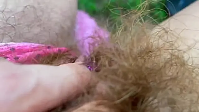 Sunbathing super sleaze exposes bushy beaver in steaming hot tease