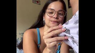 Busty brunette nerd giving a deep blowjob to Wellington Prado's big dick with her back to the mirror in denim shorts